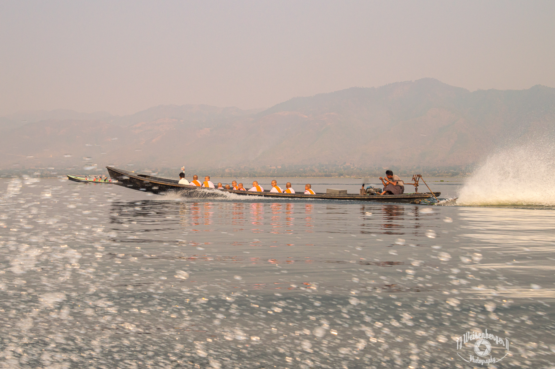 Thilashin, Burmese Buddhist Nuns - Inle Lake, Myanmar; Asia; Basket; Bhikkhuni; Boat; Buddhism; Buddhist; Burma; Burmese; Canoe; Environment; Famous Place; Inle; Inle Lake; Lake; Landscape; Landscape - Scenery; Longtail; Mountain; Nun; Nuns; People; Photography; Planet Earth; Scenics - Nature; Skiff; Southeast Asia; Spring; Sunny; Sunset; Thilashin; Tourism; Tradition; Traditional; Travel; Travel Destinations; Water; inya lake; myanmar; nature; outdoors; T.J.; TJ; Weiseberger