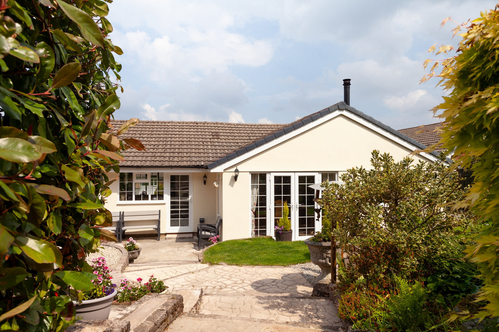 Property photography showing gardens, patio and rear of house