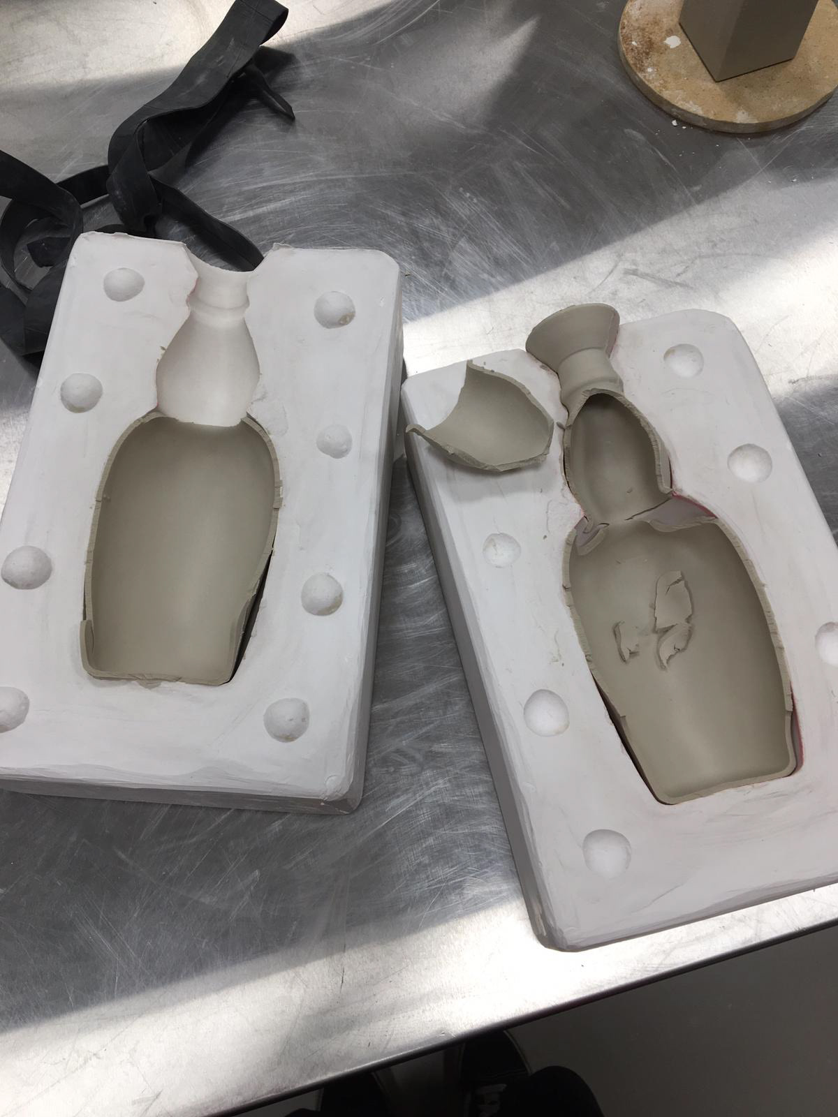 Plaster mould and broken clay bottle.