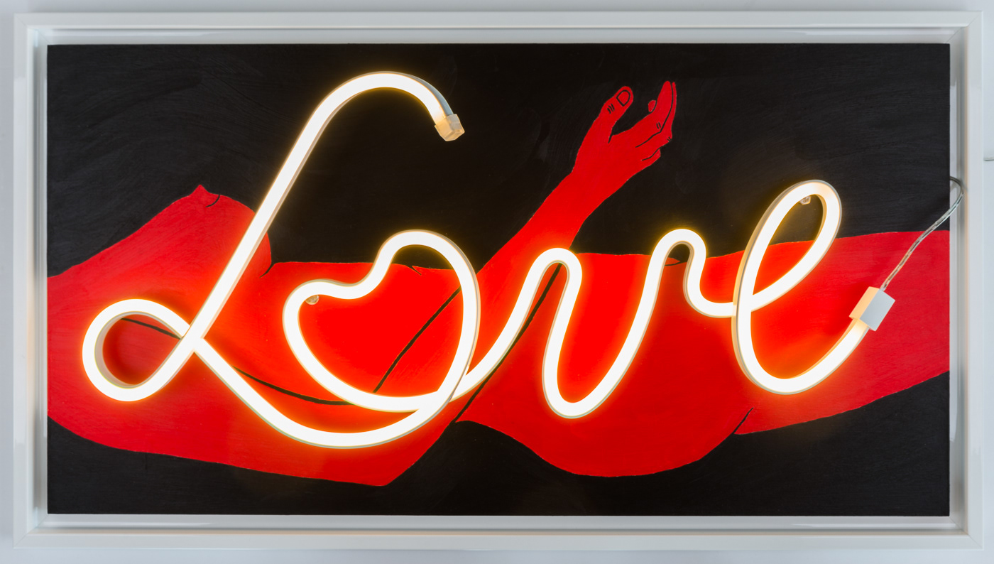 A sensual female nude painted red lies against a black background. An LED light spells the word LOVE. White coloured frame. It is dramatic and sensual