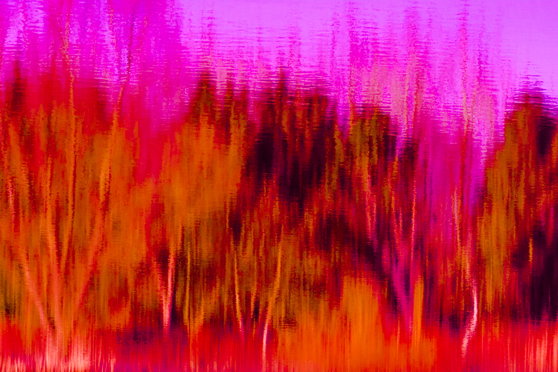 Vivid red orange colored reflections on rippled water