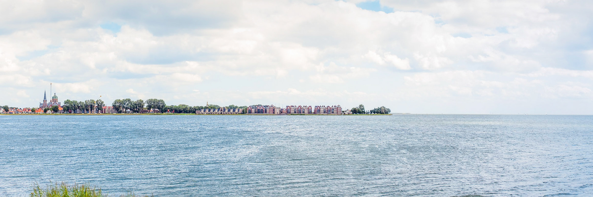 Bright light colored distant view on Hoorn over Markermeer