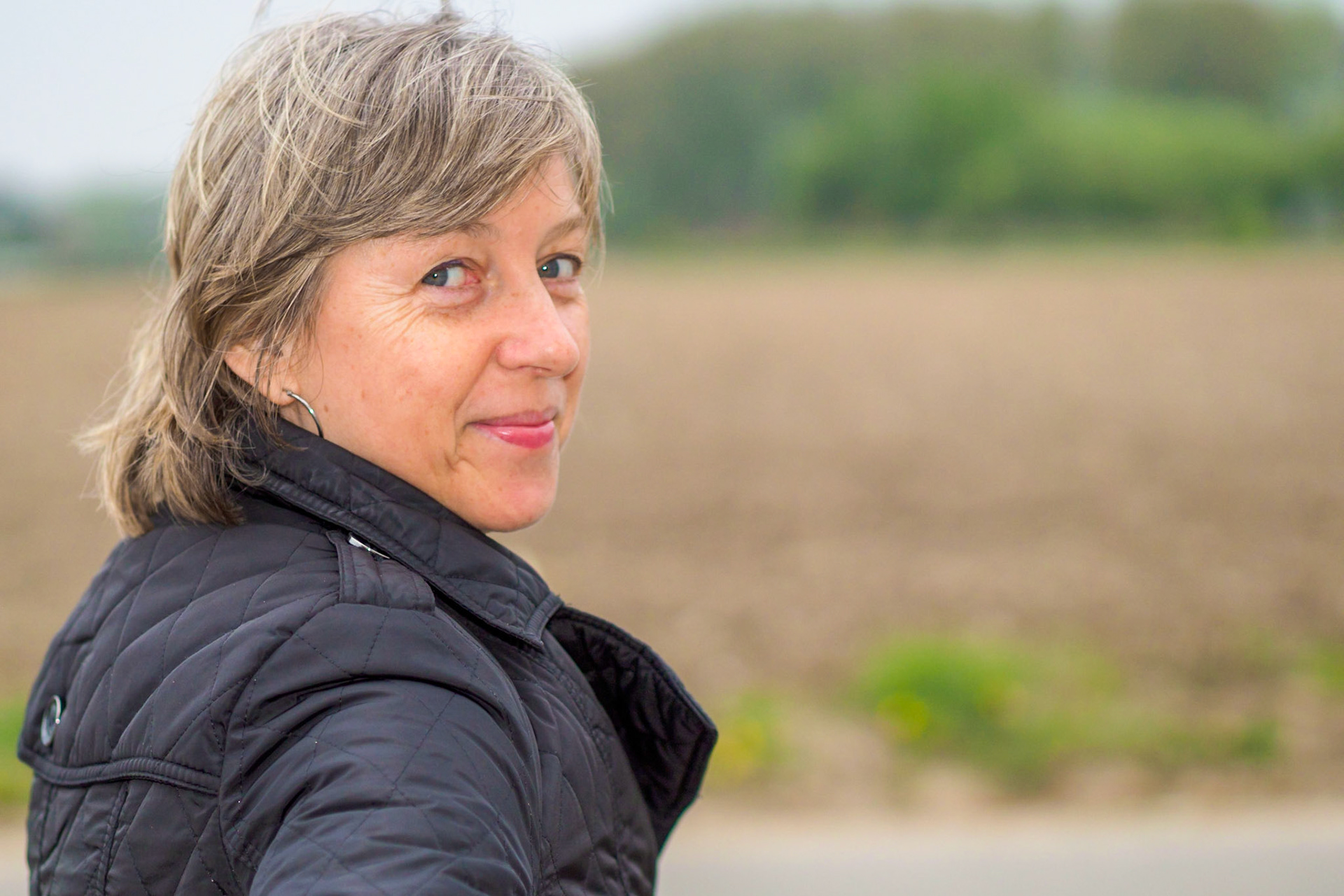 Adult female looking back over shoulder - smiling