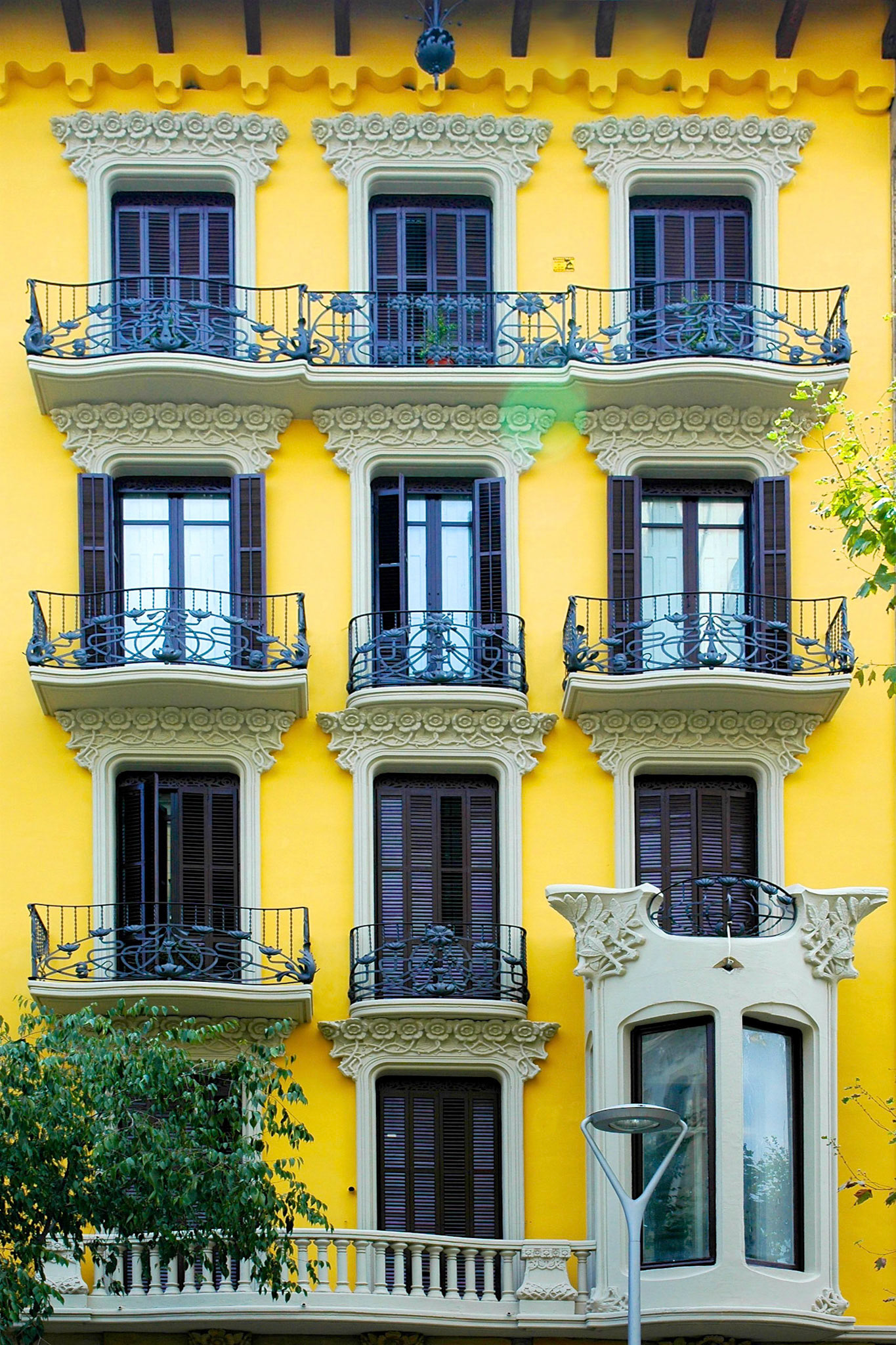 Decorated windows, doors and railings on an apartment building in Barcelona