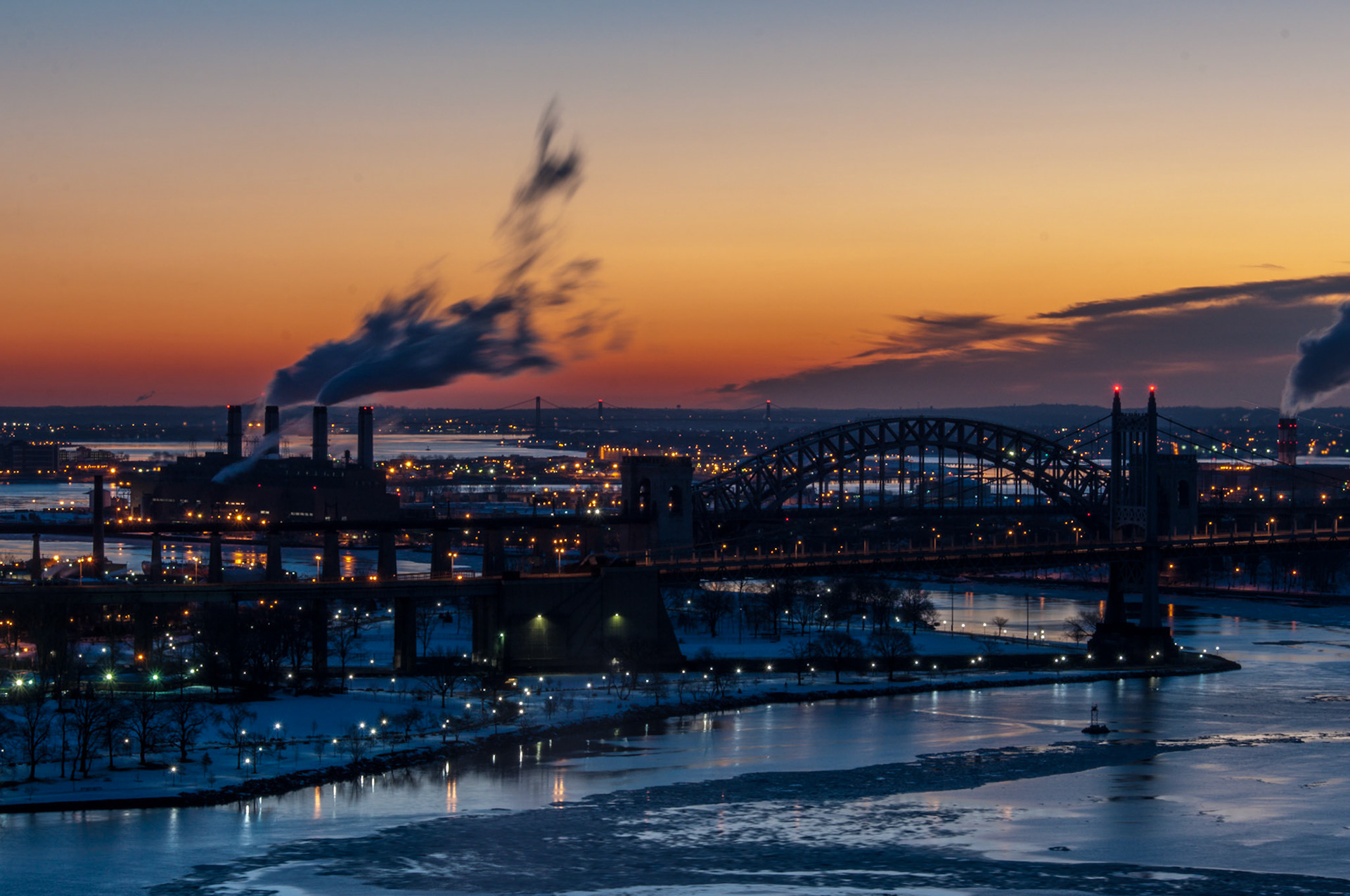 Ice collects at Hell Gate, where the East River and Harlem River connect. The Triboro Bridge and Hell Gate Bridge are in the foreground.  The Throgs Neck and Whitestone Bridges are in the background.