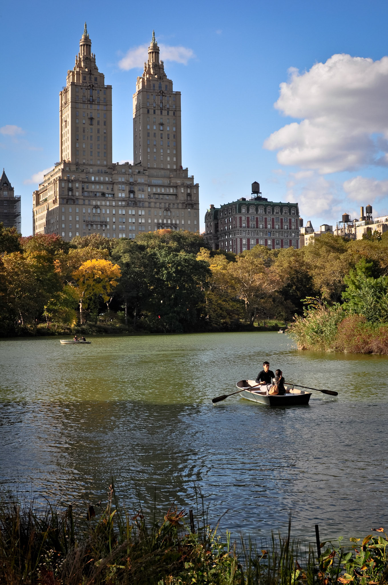 A couple enjoys the fall leaves  in a row boat on The Lake in Central Park.   The Lake was completed in 1858.   The San Remo Apartments, located on Manhattan's 74th Street, can be seen in the background.  The San Remo was built in 1931 and has been home to many famous New Yorkers.   

10/2012