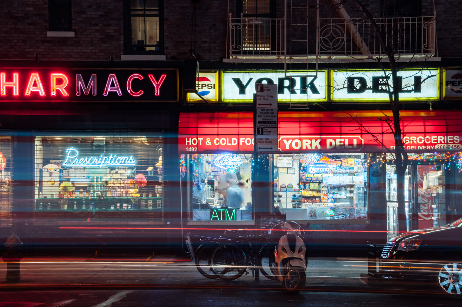 Neon lights at a deli and pharmacy on York Avenue in Yorkville, Upper East Side.